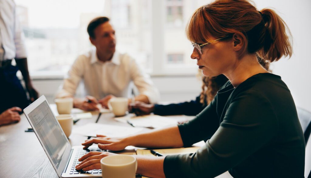 Businesswoman using a laptop in a meeting